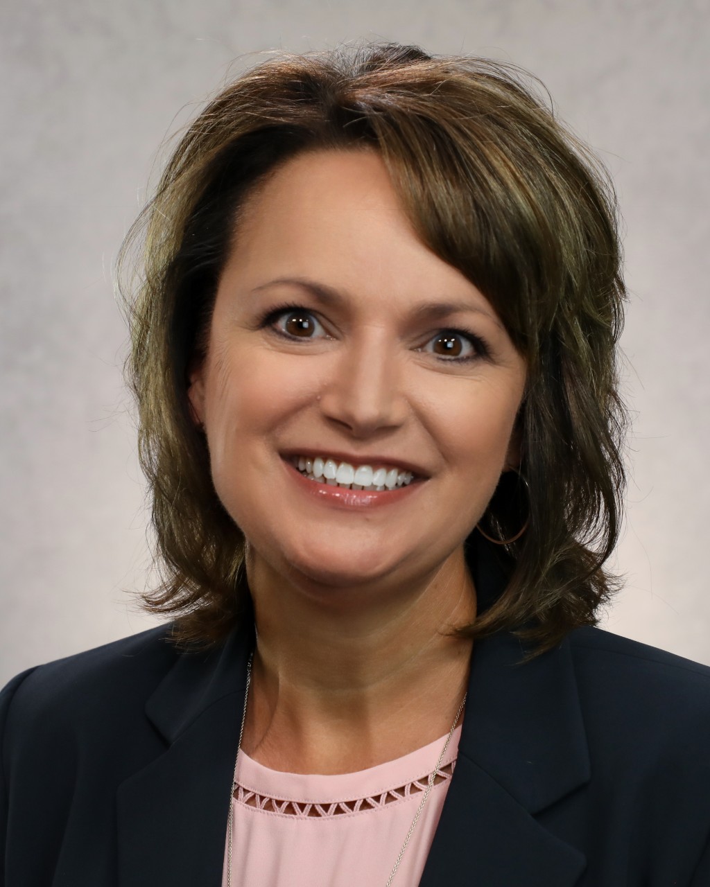 Susan Bailey wears a light shirt and dark jacket.