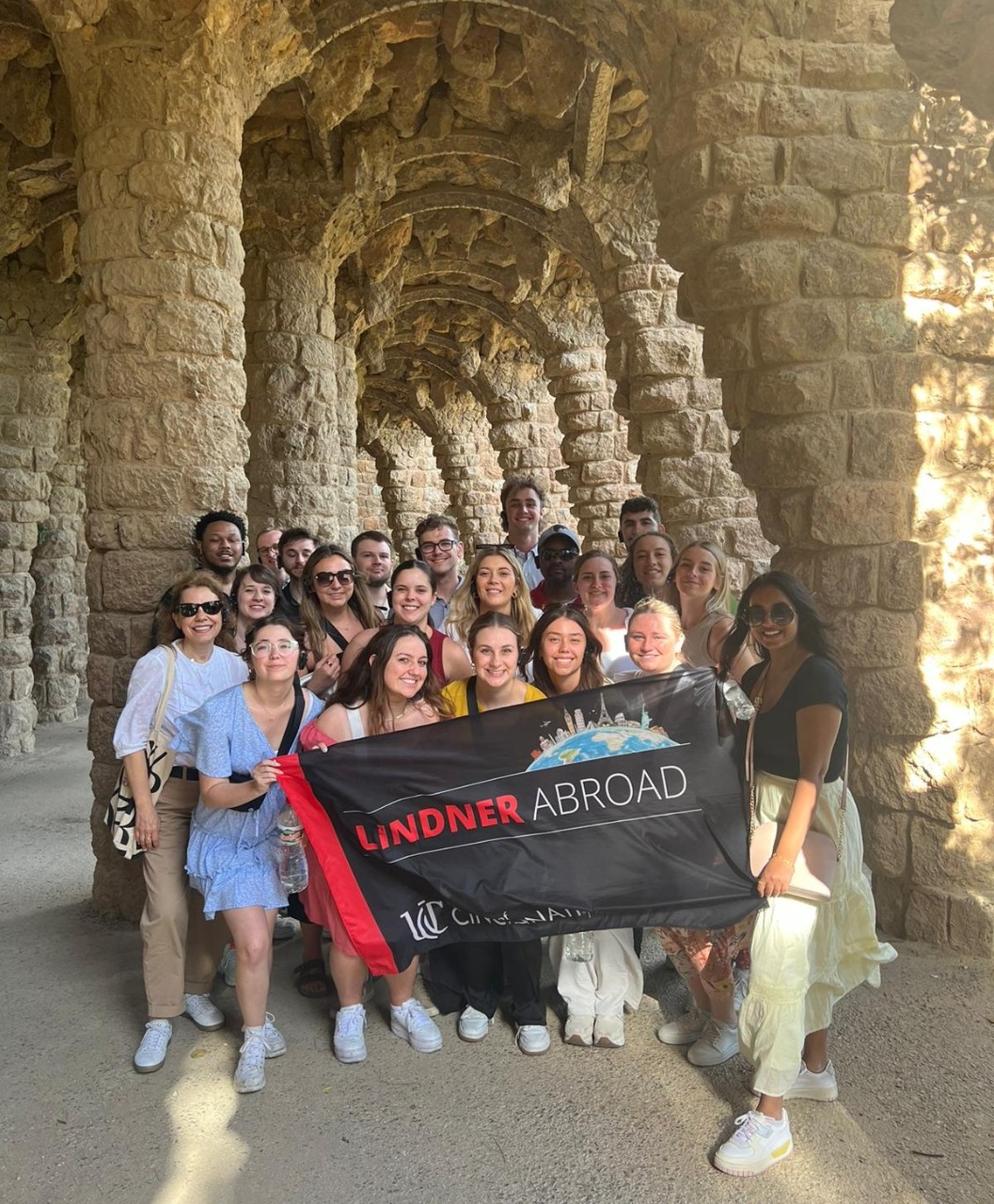 Lindner students holds a flag during a study abroad trip.