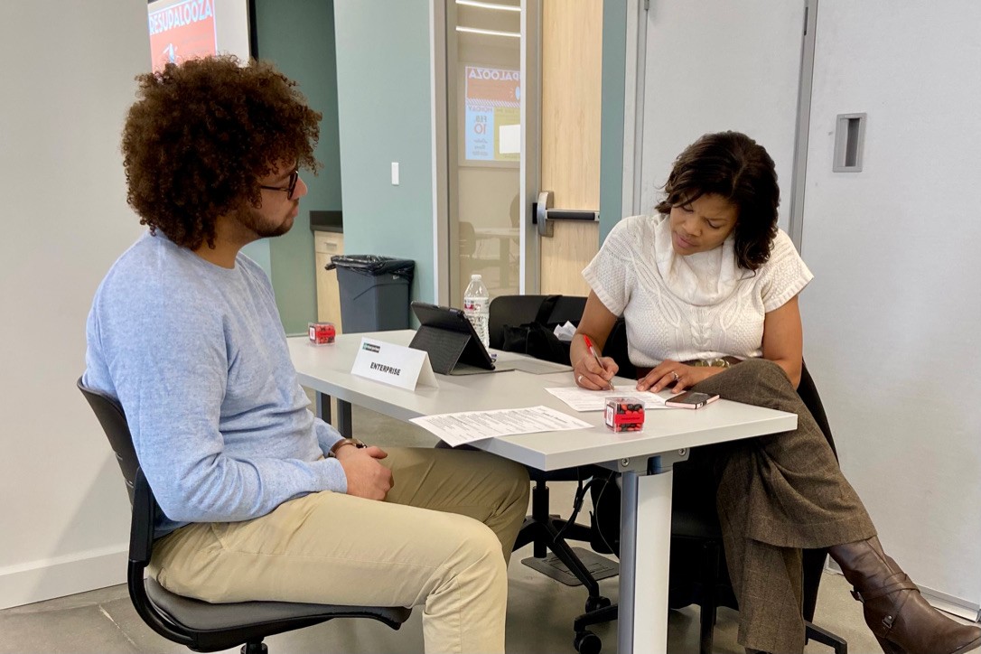 Two people sitting at a desk.