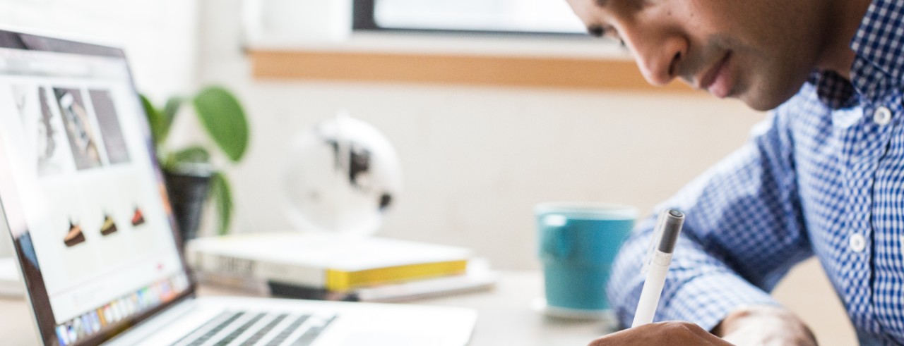 man writing in a notebook